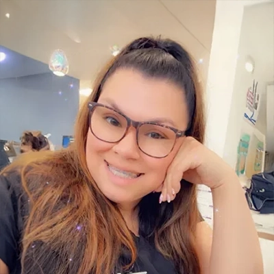 Alyssa smiling while wearing glasses.