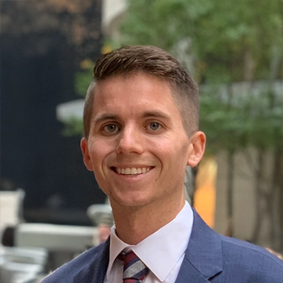 Dr. Connor Sexton smiling in a suit.