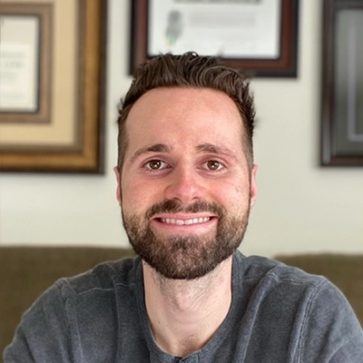 Dr. Seamus Allen smiling in a grey shirt.